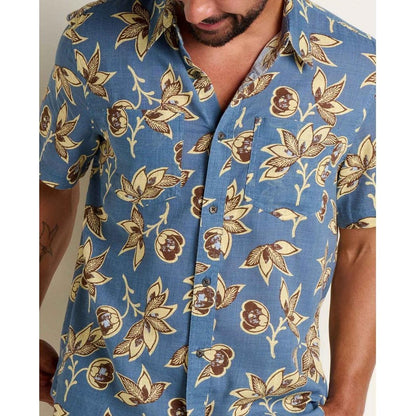 A model wears the Toad & Co Men's Salton Short Sleeve Shirt in Pacific Blue Print, showing the front and a pocket against a plain background.