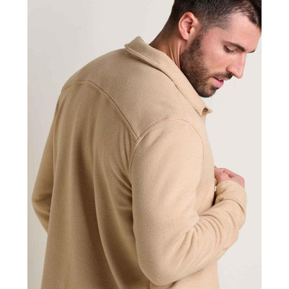 Side view of the Toad & Co Men's Shadowbrook Long Sleeve Shirt in Camel Twill showing the collar and sleeve against a plain background.