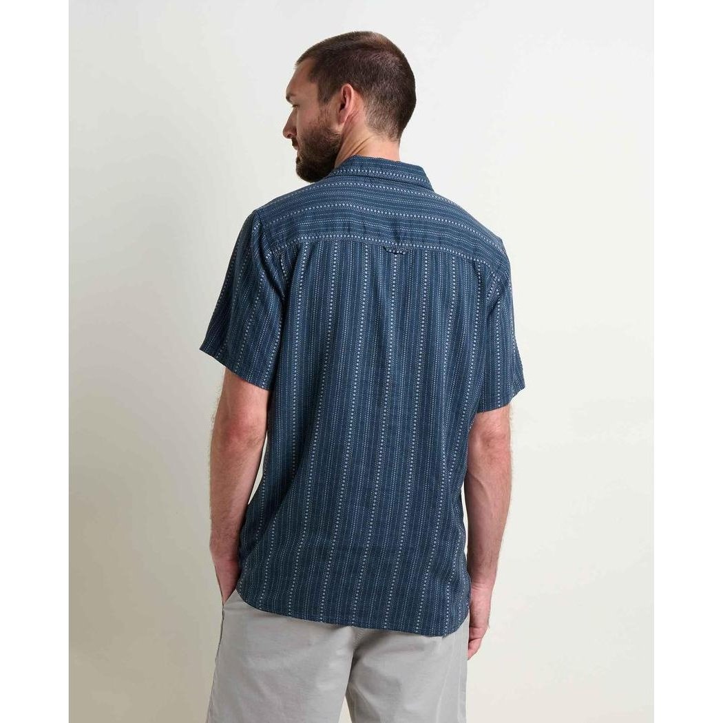 Back view of the Toad & Co Men's Taj Hemp Short Sleeve Shirt in Midnight Dobby on a model wearing light gray shorts against a plain white background.