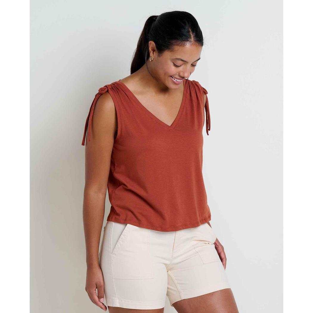 A woman wearing the Toad & Co Women's Anza Cinch Tank in Cinnamon stands against a plain white background.