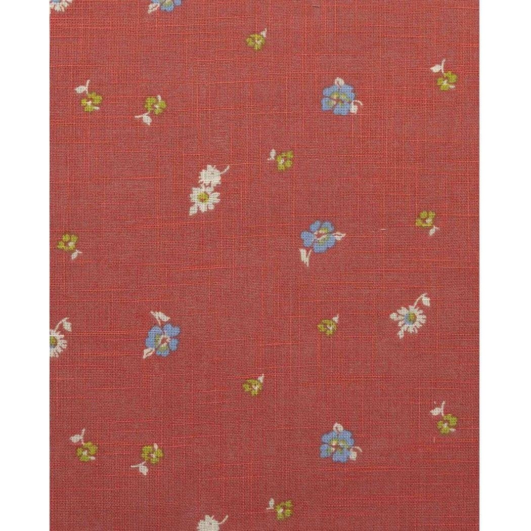 A close-up of the Toad & Co Women's Camp Cove Shirt in Crabapple showing small blue and white flowers on a red background.