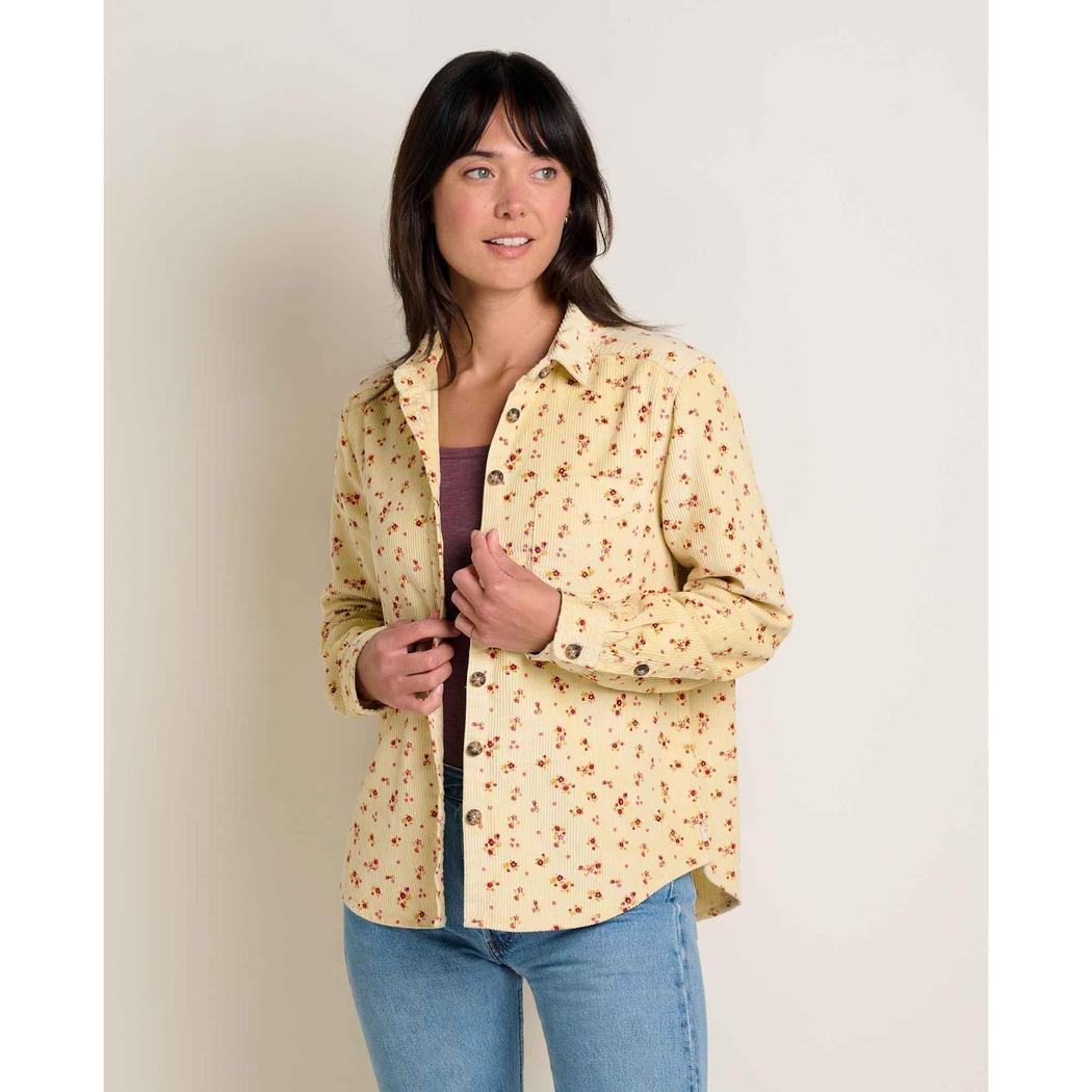 A woman wearing the Toad & Co Women's Cascadia Long Shirt in Barley Floral Print stands against a plain white background.