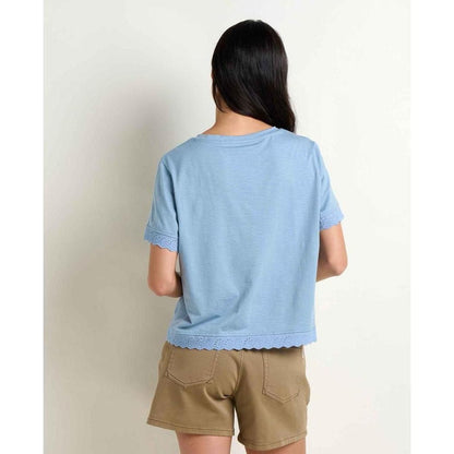 Back view of the Toad & Co Women's Clara Tee in Weathered Blue on a model wearing khaki shorts against a plain white background.