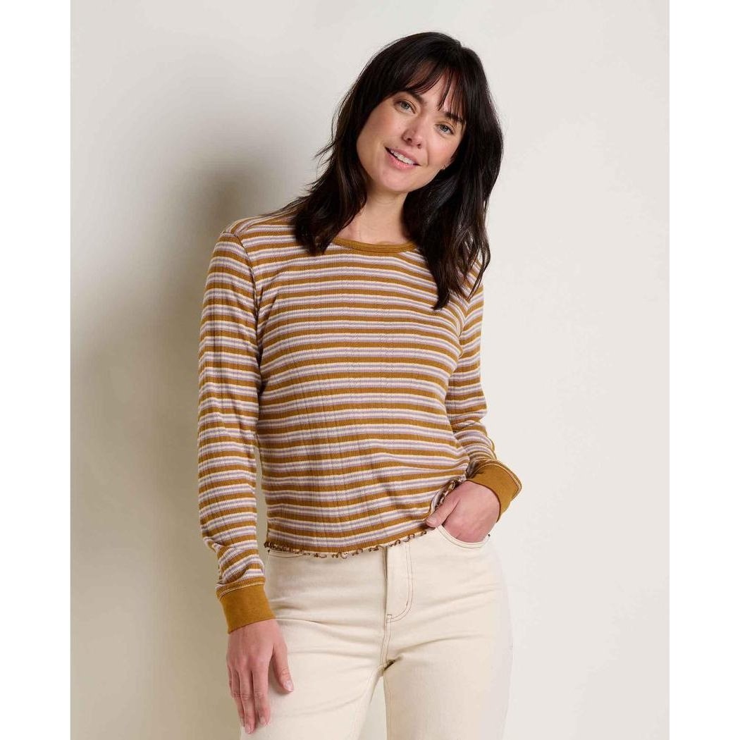 A woman wearing the Toad & Co Women's Foothill Pointelle Long Sleeve Crew II in Kelp Stripe stands against a plain white background.