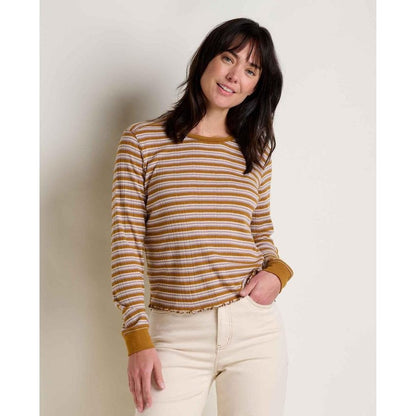 A woman wearing the Toad & Co Women's Foothill Pointelle Long Sleeve Crew II in Kelp Stripe stands against a plain white background.