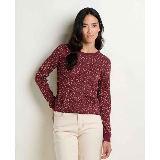 A woman wearing the Toad & Co Women's Foothill Pointelle Long Sleeve Crew II in Kelp Stripe stands against a plain white background.