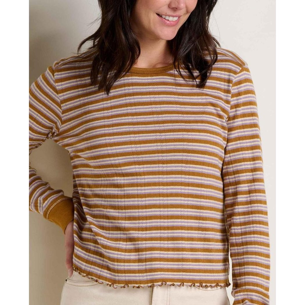 A woman wears the Toad & Co Women's Foothill Pointelle Long Sleeve Crew II in Kelp Stripe, showing the long sleeves and crew neckline against a neutral background.