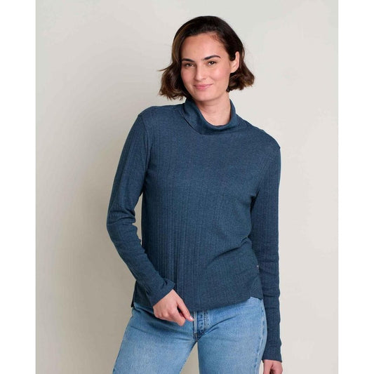 A woman wearing the Toad & Co Women's Foothill Pointelle Long Sleeve T-Neck in Midnight stands against a plain background.