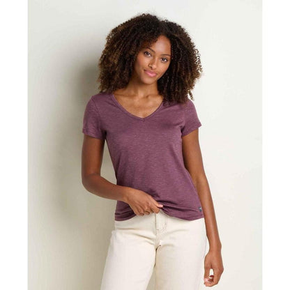 A woman wearing the Toad & Co Women's Marley II Short Sleeve Tee in Earth color stands against a plain light background.