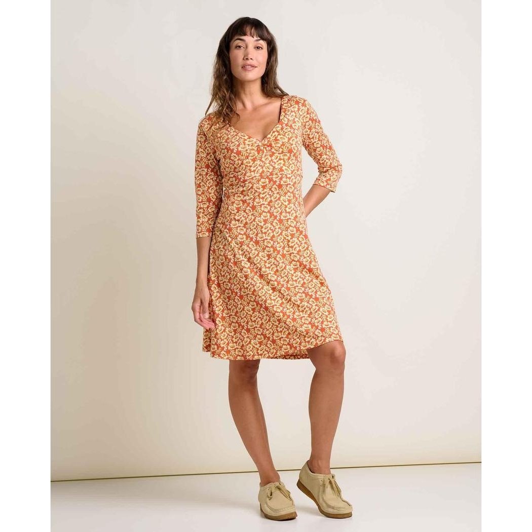A woman wearing the Toad & Co Women's Rosalinda Dress in GourdIkatPrint stands against a plain white background.