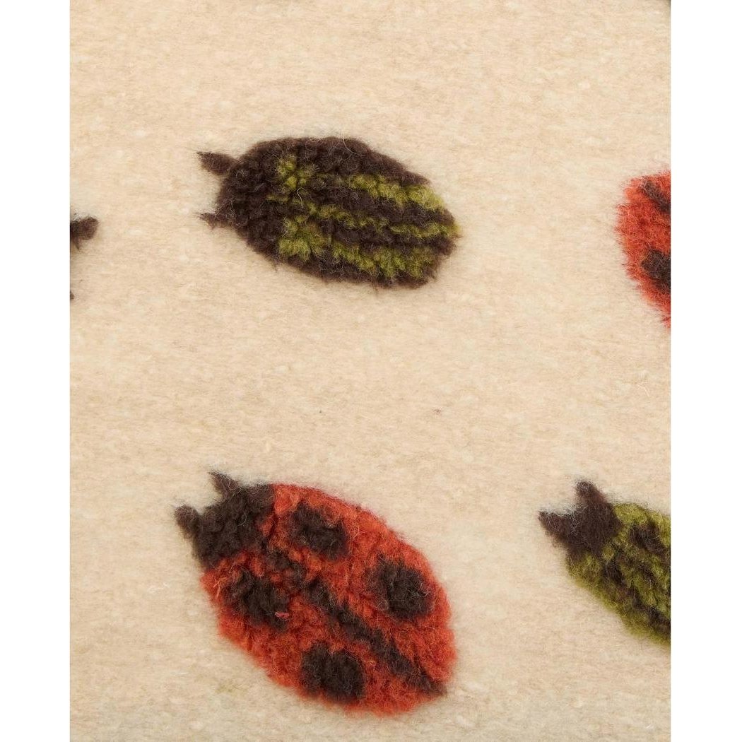 A close-up of the Toad & Co Women's Sespe Sherpa Vest in Barley Ladybugs showing the ladybug pattern on the fabric.