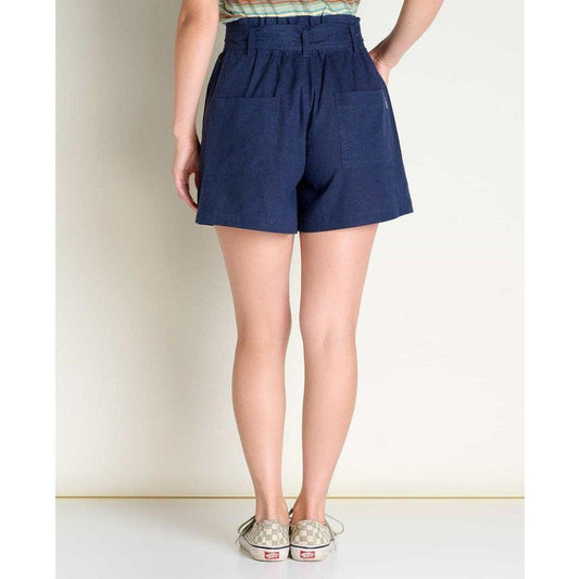 Back view of the Toad & Co Women's Tarn Short in True Navy on a model wearing checkered sneakers against a plain wall.