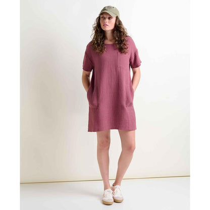 A woman wearing the Toad & Co Women's Tate Double Weave Short Sleeve Dress in Wild Ginger stands against a plain white background.