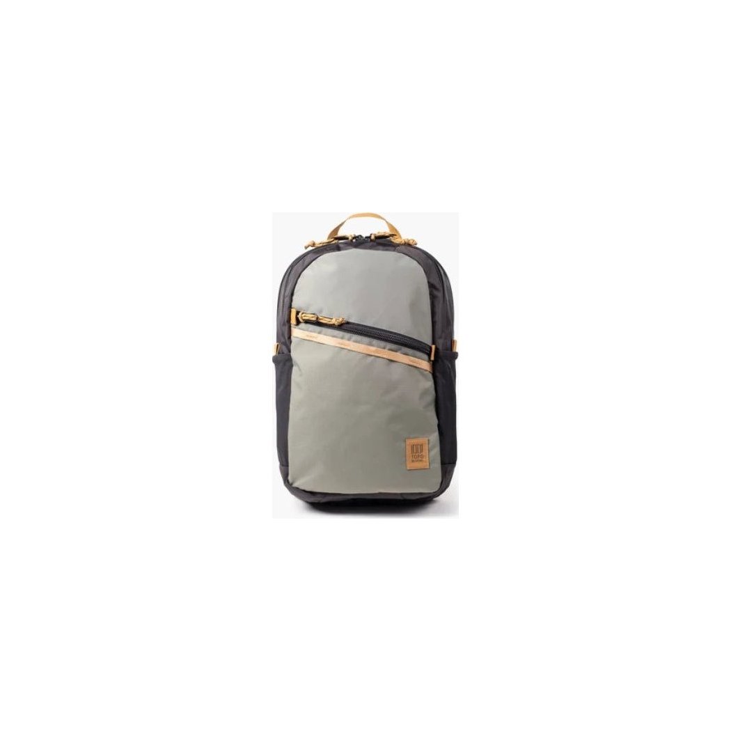 A front view of the Topo Designs Commuter Backpack in Beetle/Khaki with a diagonal zipper pocket and tan accents against a white background.
