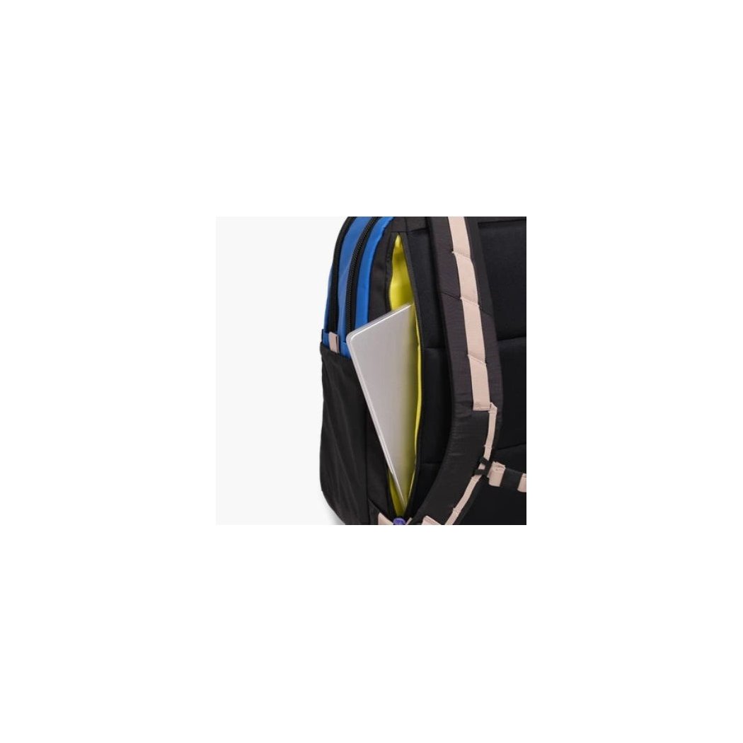 Side view of the Topo Designs Commuter Backpack in Beetle/Khaki showing the laptop compartment against a white background.