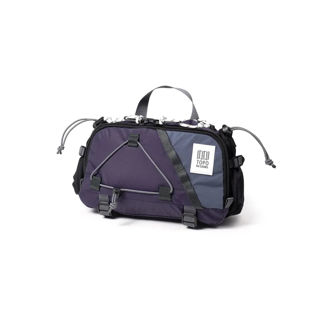 A front view of the Topo Designs Mountain Hydro Hip Pack in Black/Neutral with a white background.