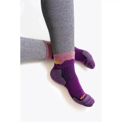 A side view of the Tough Cuties Eve The Original Ladies Light Weight Hiker Quarter Horizon socks in Twilight Blue Horizon, showing the heel and toe cushioning against a white background.