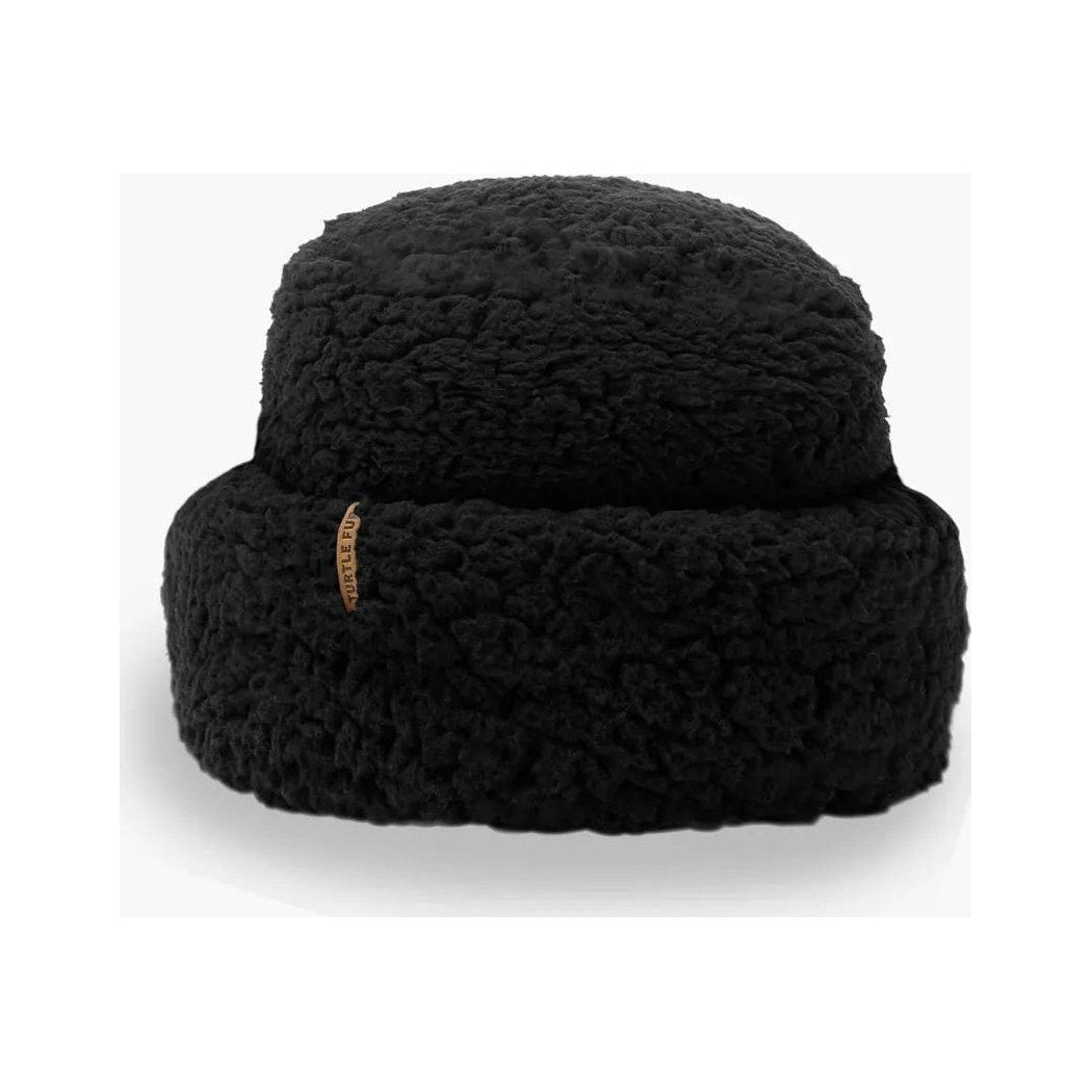 A front view of the Turtle Fur Comfort Lush Après Tort hat in Black with a small tag on the side against a white background.