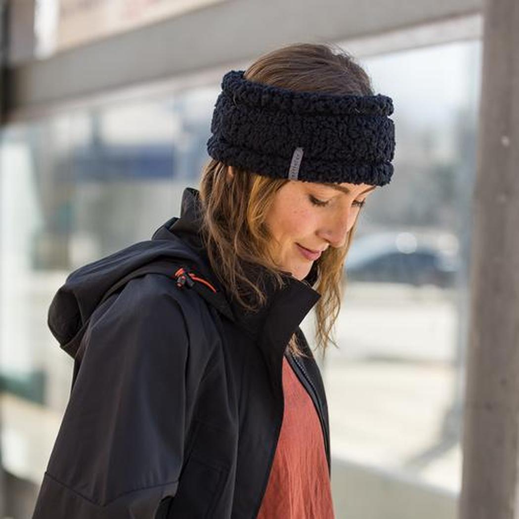 A woman wearing the Turtle Fur Comfort Lush Full Send Wide Band in Black stands outside near a window.