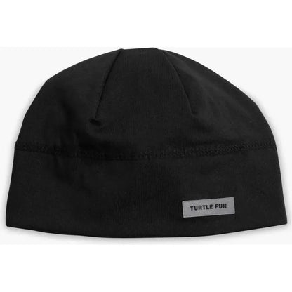 A front view of the black Turtle Fur Comfort Shell Brain Shroud hat with a label on the front against a white background.