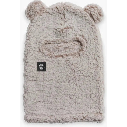 Natural Turtle Fur Kids Comfort Lush Bear Balaclava with bear ears and a black logo patch, shown from front against white background.