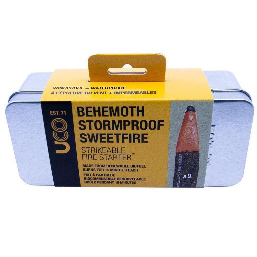 A front view of the UCO Behemoth Stormproof Sweetfire Strikeable Fire Starter in a silver tin with a yellow label showing the product name and a close up of the fire starter.