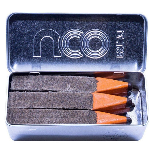 Open metal tin of UCO Behemoth Sweetfire Match Kit showing three matches with charcoal/graphite heads and orange tips inside.