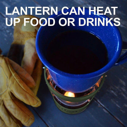 A green UCO Candlelier heats a blue mug of dark liquid on a wooden surface with leather gloves nearby.