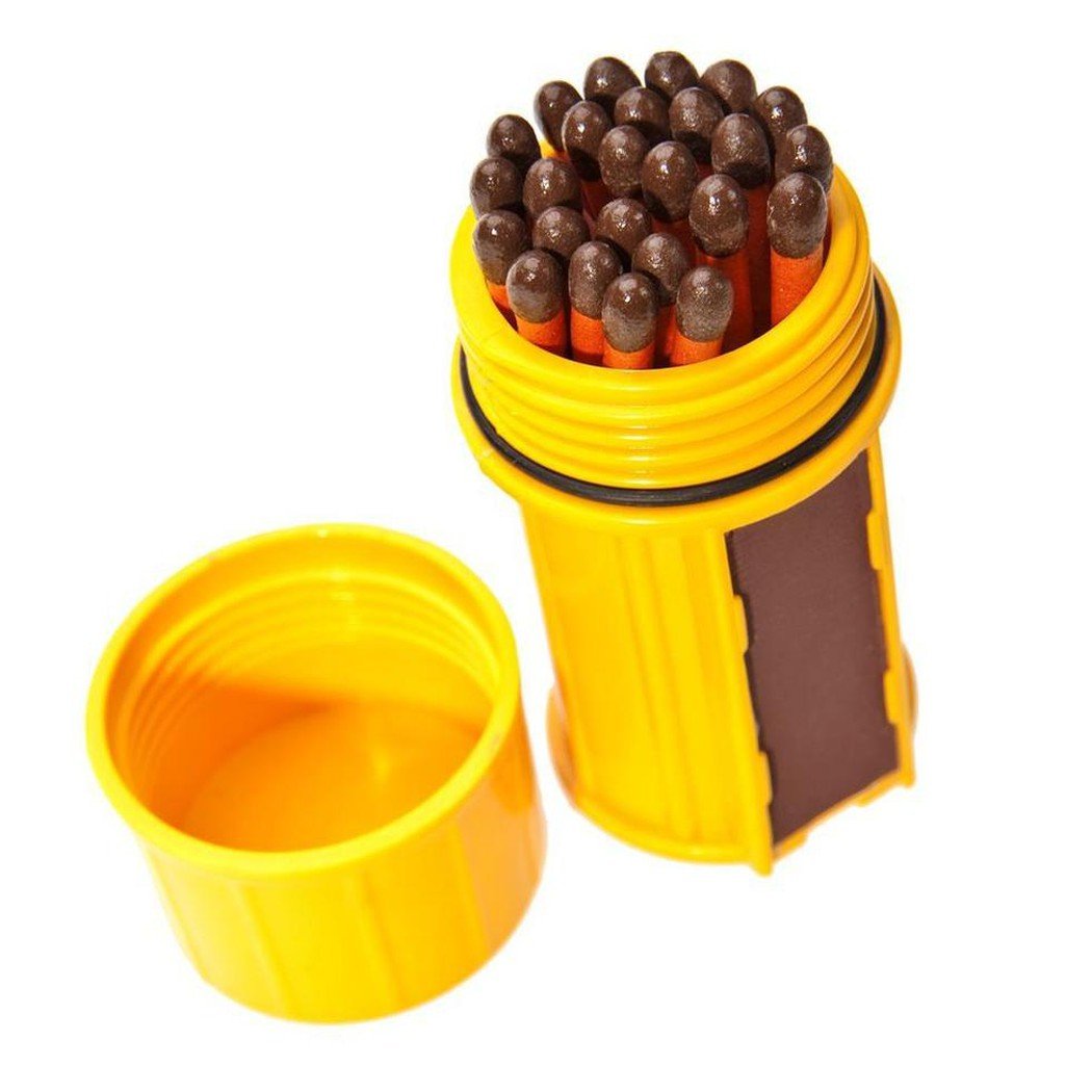 A yellow UCO Stormproof Match Container - 25 Matches with its lid off, showing the matches and a dark green panel on the side.