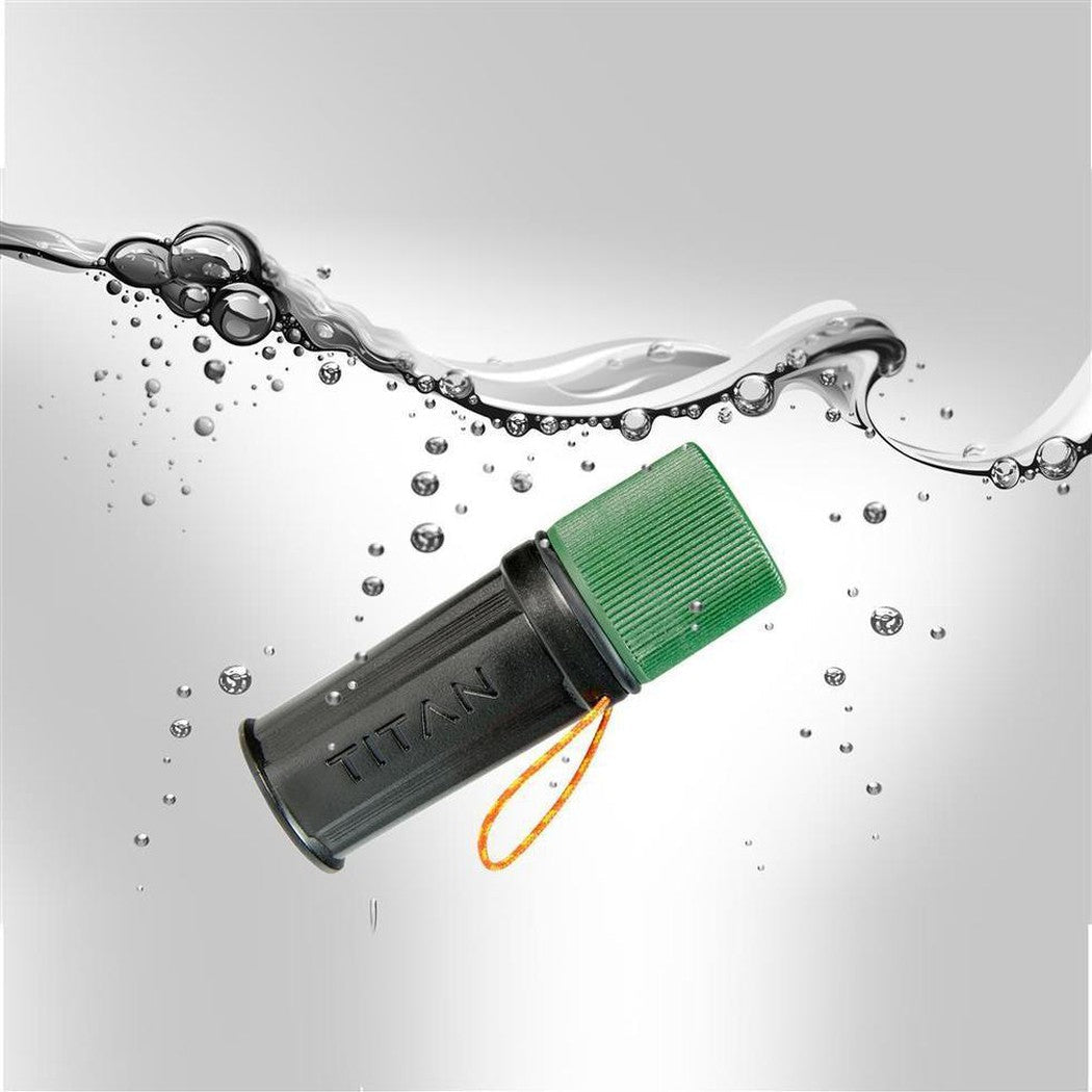 A side view of the UCO Titan Stormproof Match Kit with a green cap and orange lanyard floating in water.