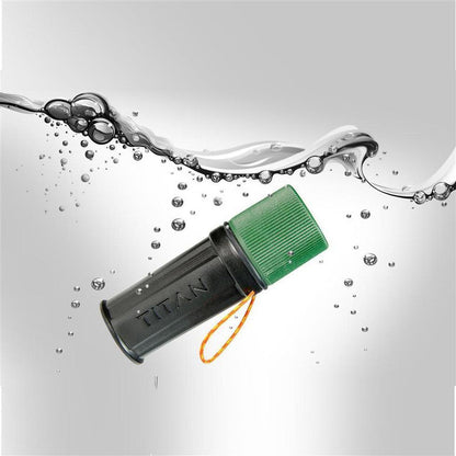 A side view of the UCO Titan Stormproof Match Kit with a green cap and orange lanyard floating in water.