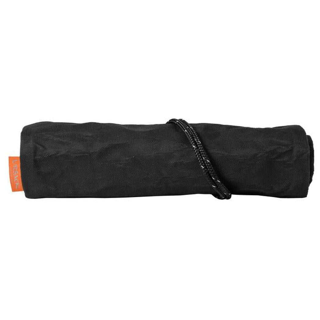 A rolled-up black Ursack Allmitey Grizzly food storage bag with an orange tag and a black cord, photographed from a front angle against a white background.