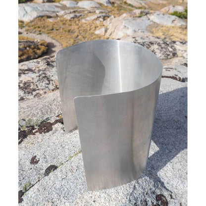 A side view of the Ursack Aluminum Liner on a rocky outdoor surface with a natural background.