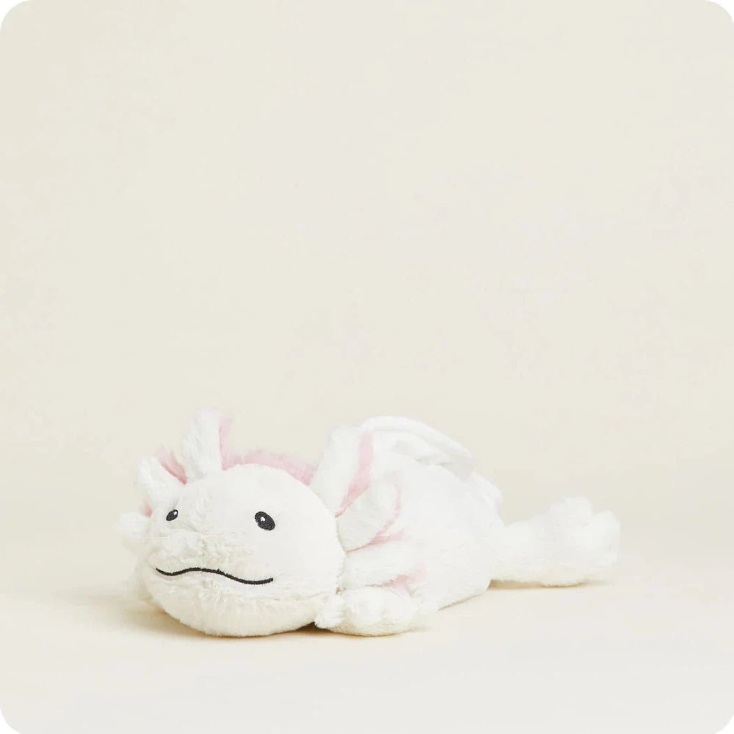 A white Warmies Axolotl plush toy lies on a light background.
