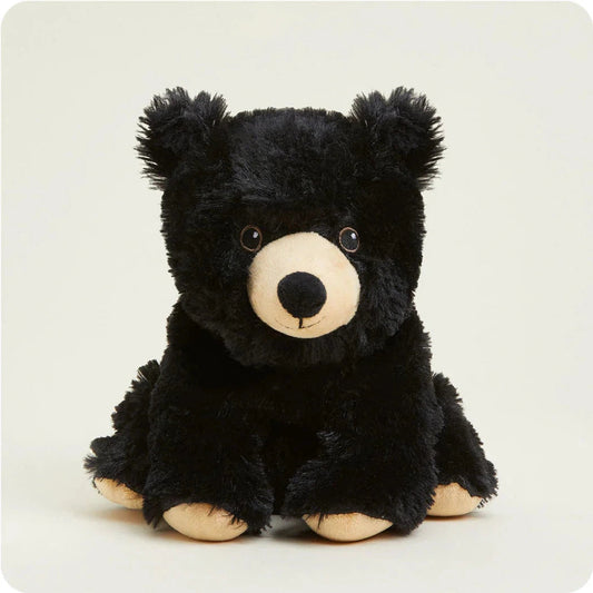 A front view of the Warmies Bear plush toy with black fur and tan accents sitting against a plain white background.