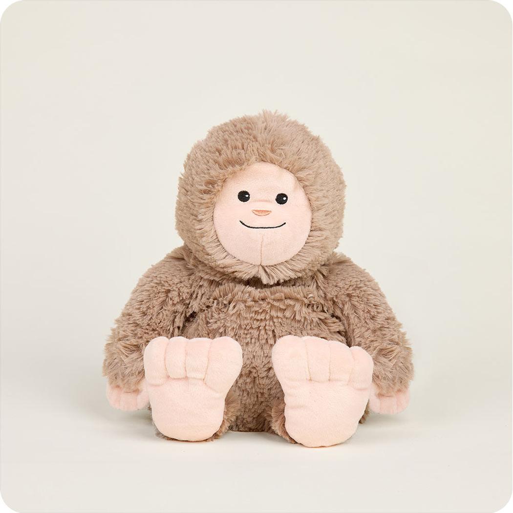 A front view of the Warmies BigFoot plush toy with its large feet visible against a plain background.