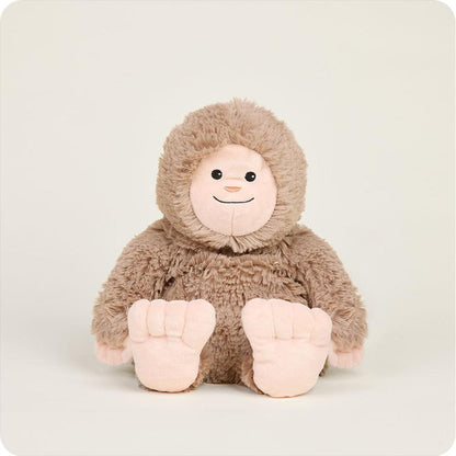 A front view of the Warmies BigFoot plush toy with its large feet visible against a plain background.