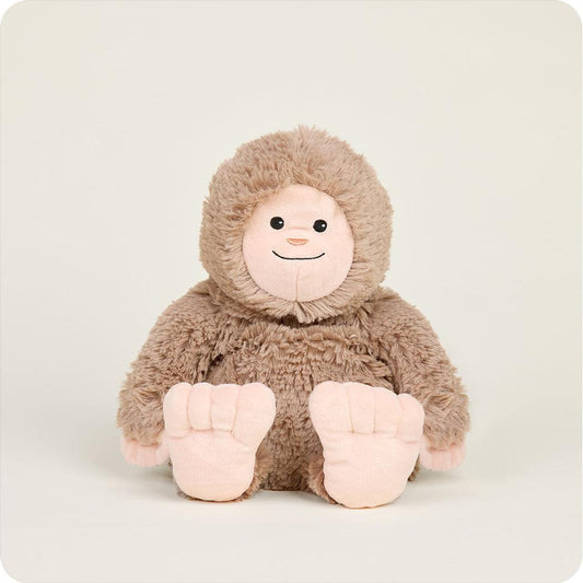 A front view of the Warmies BigFoot plush toy with its large feet visible against a plain background.