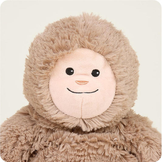 A close-up of the Warmies BigFoot plush toy showing its soft brown fur and friendly face against a plain white background.