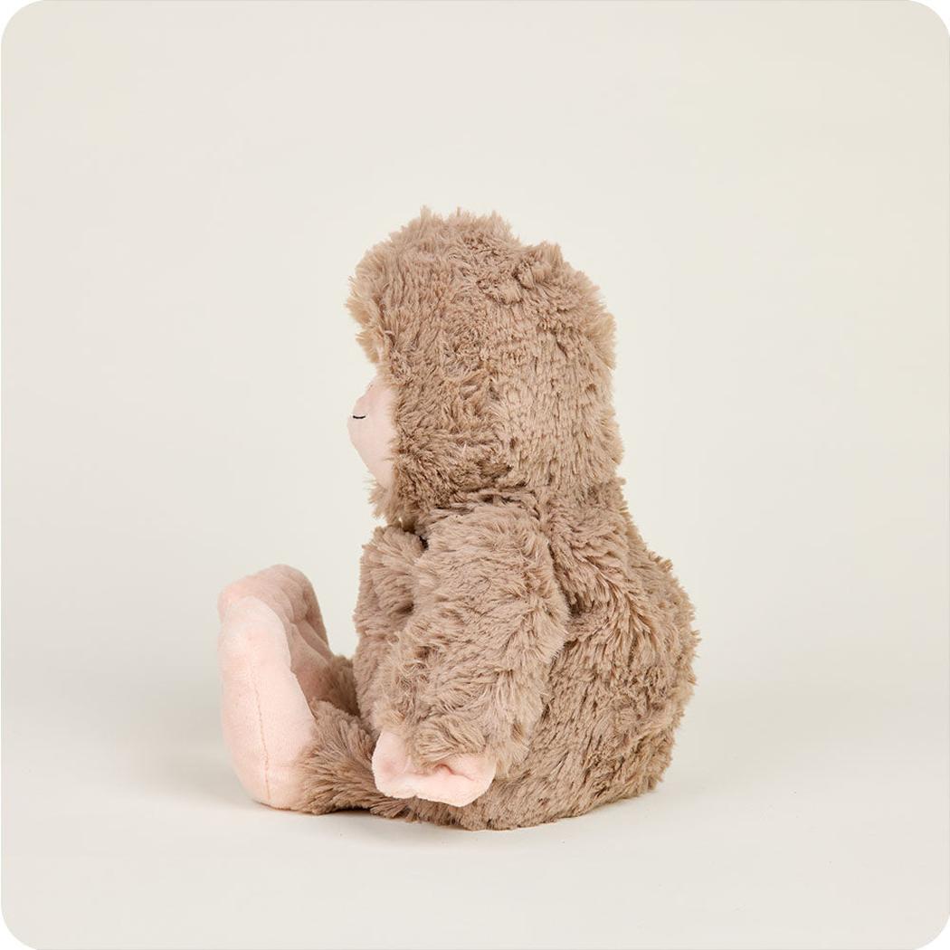 Side view of the Warmies BigFoot plush toy sitting against a plain white background.