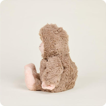 Side view of the Warmies BigFoot plush toy sitting against a plain white background.