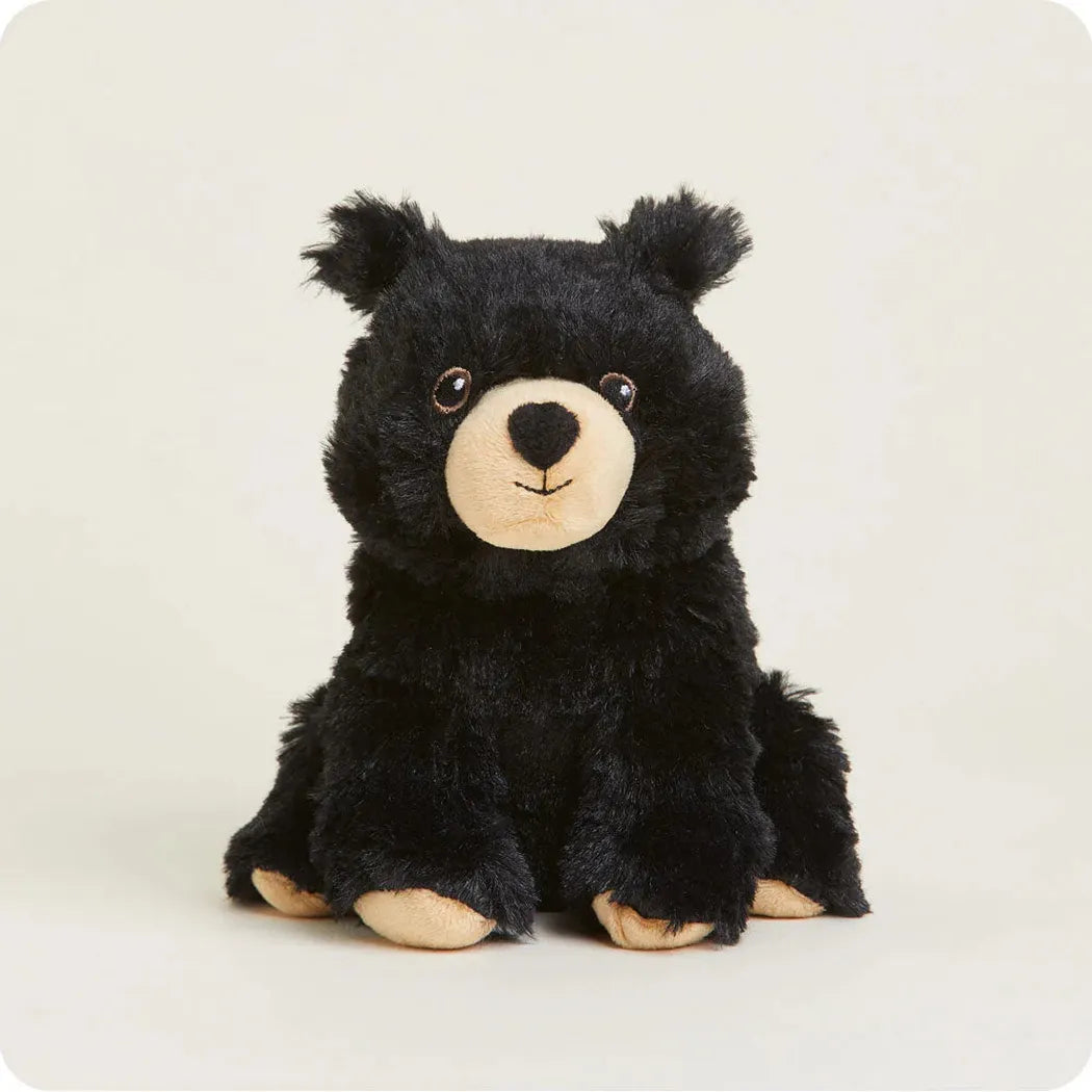 A front view of the Warmies Black Bear Junior plush toy with a light background.