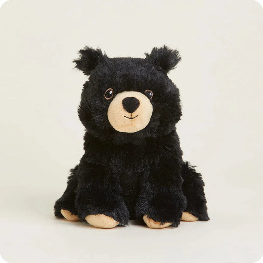 A front view of the Warmies Black Bear Junior plush toy with a light background.
