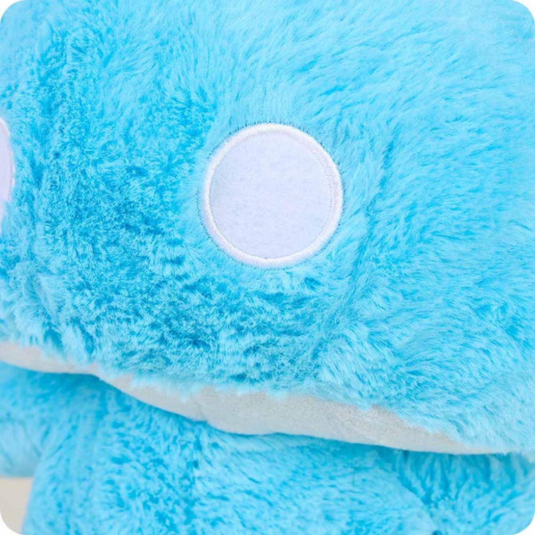 Close-up of the Warmies Blue Mushroom showing the blue plush texture and white circular detail.