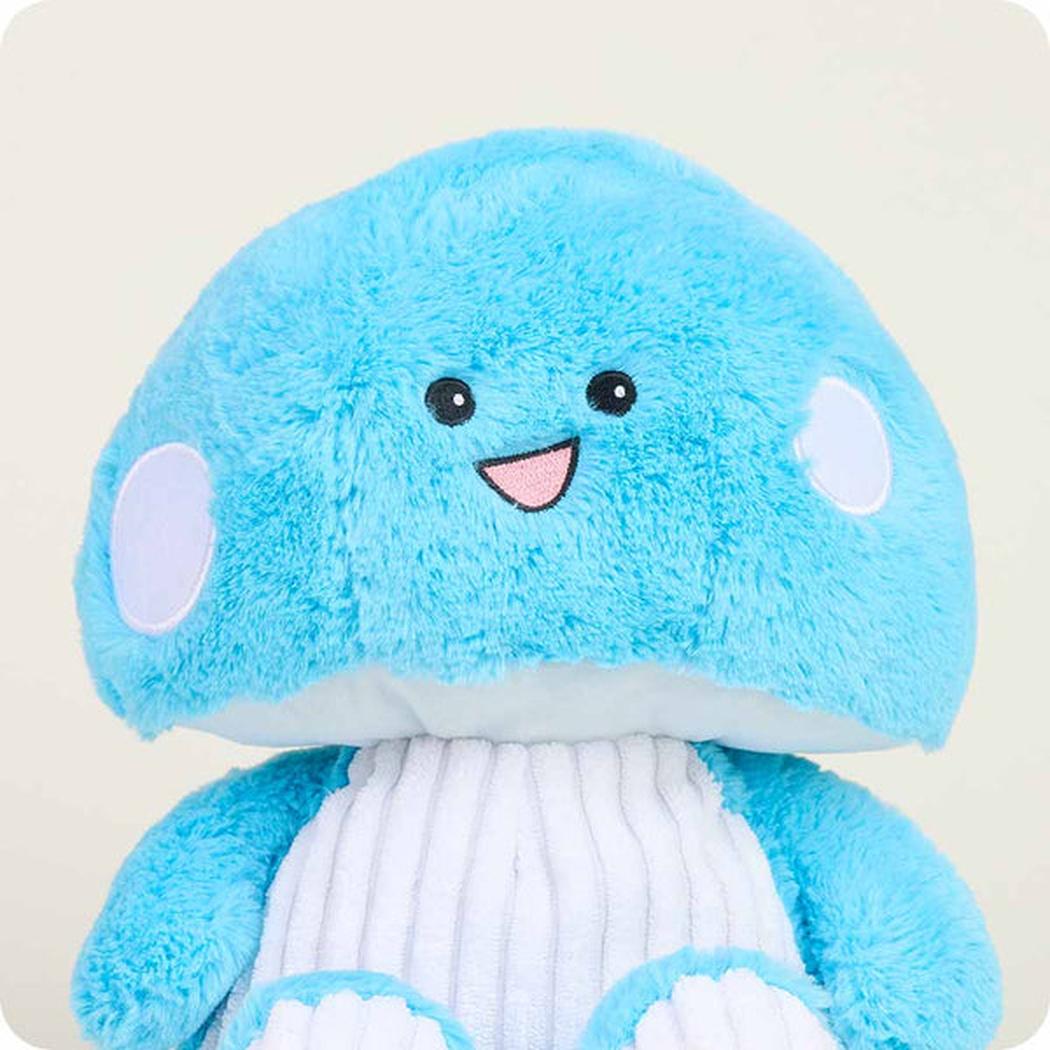 A close-up of the Warmies Blue Mushroom plush toy with a white ribbed belly and light blue accents, set against a plain background.
