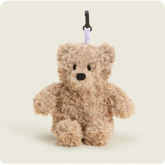 A close-up of the Warmies Brown Curly Bear Bag Charm hanging from a black carabiner against a plain white background.