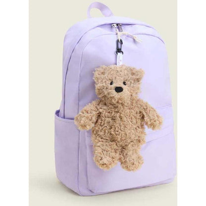A light purple backpack with a small brown curly bear bag charm attached to the front pocket.