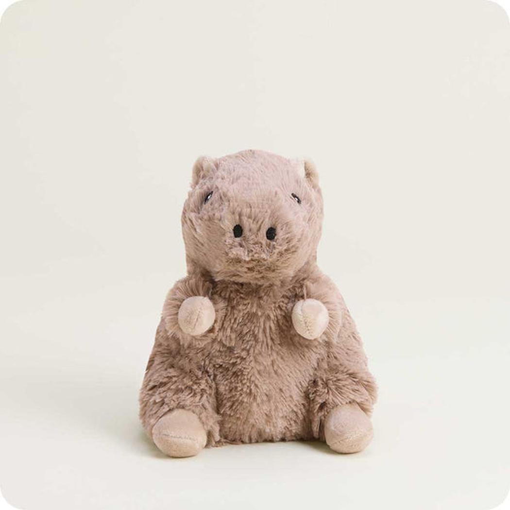 A front view of the Warmies Capybara Junior plush toy with a soft, light brown fur texture and small, round paws, set against a plain white background.