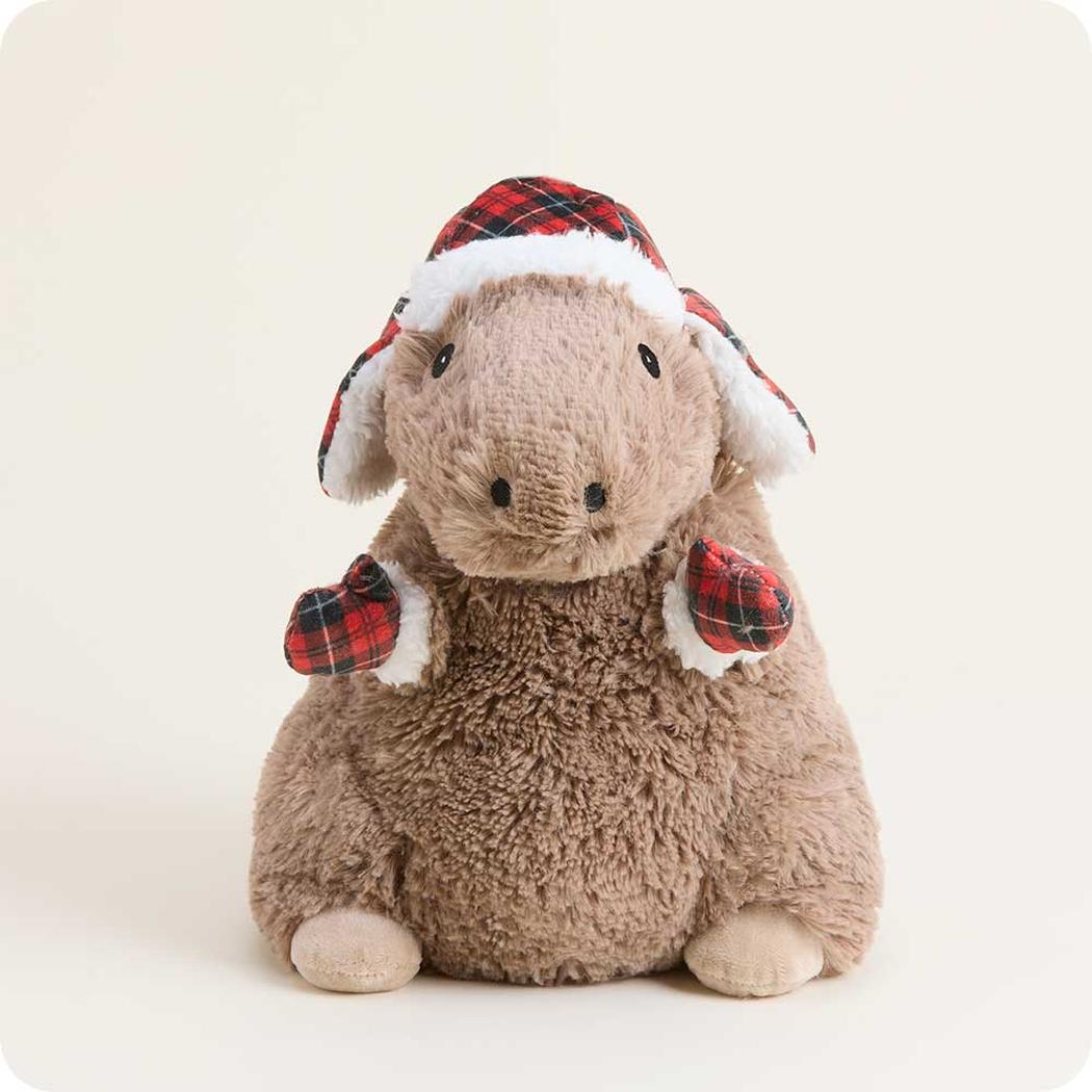 A front view of the Warmies Cozy Capybara wearing a plaid Santa hat and matching mittens against a plain white background.