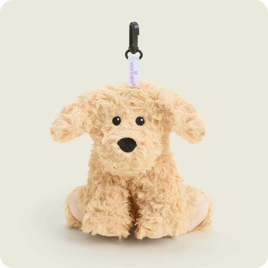 A front view of the Warmies Curly Dog Bag Charm with a black clip and white tag against a light background.